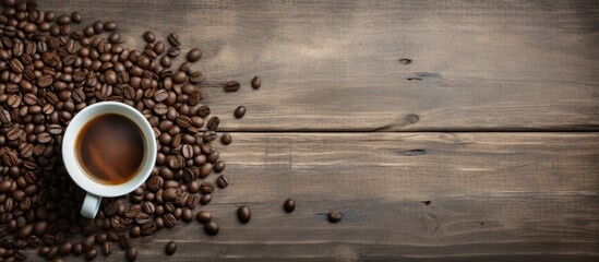 Canvas Print - Top view of an old kitchen table with space for text, displaying a coffee cup and beans.