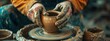 Dirty male hands sculpt mug with ceramic clay on potter's wheel