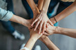 © Papar Krub - Close up top view of business people putting their hands together. Friends with stack of hands symbolizing their unity and support and teamwork. Team set up for productive work and a positive result.