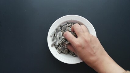 Poster - top view of hand picks sun flower seeds 