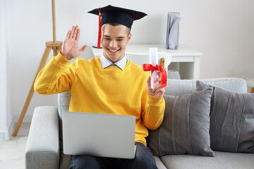 Poster - Male graduate student with diploma and laptop video chatting at home