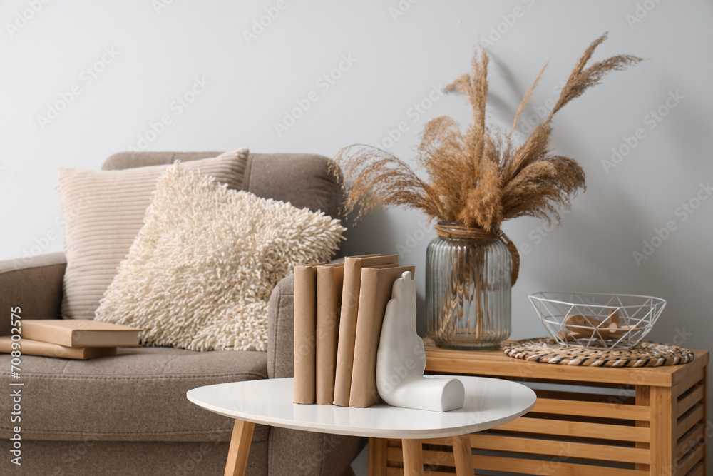 Holder with books on table in living room