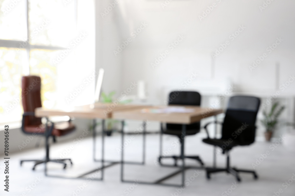 Blurred view of modern office with desks