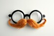 Happy april fool s day and funny pranks concept with a pair of comical glasses with bushy eyebrows and thick mustache