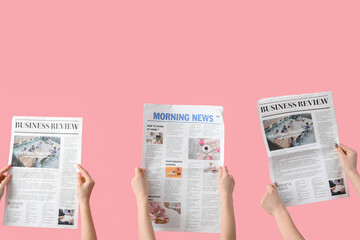 Poster - Women with newspapers on pink background