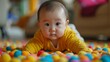 © AI Visual Vault - Curious Infant Amongst Colourful Balls.Description: Baby in yellow crawling in a colourful ball pit.