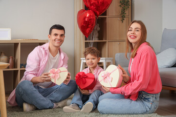 Wall Mural - Little boy with his parents and gift boxes at home on Valentine's Day