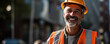 © Yeti Studio - Smiling construction worker wearing a white hard hat and reflective vest stands at a construction site. Copy space