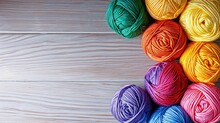 Rows Of Colorful Yarn Balls Tightly Packed Together, Showcasing A Rainbow Of Knitting Materials, Wooden Background, Space For Text