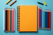 An aesthetically pleasing composition of school stationery, featuring colorful markers and notebooks, photographed in high resolution from above on a pastel solid background
