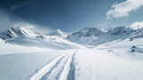 Fototapeta Do pokoju - Stunning panoramic view of snowy mountain range. The untouched powder snow with ski tracks crisscrossing. Bright and crisp winter day with snow capped peaks and clear blue sky. Cold adventure and expe