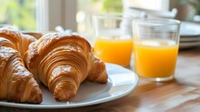 Morning Routine: A Neatly Arranged Breakfast Featuring A Freshly Baked Croissant, A Steaming Cup Of Coffee And A Newspaper On A Table