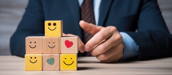 Wall Mural - Business services rated excellent with customer satisfaction survey and ISO certification ensures standards and guarantee of quality assurance. Businessman chooses smiley face on wood block.