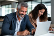 © ZaStock - Middle aged male manager mentor teaching young female. business education