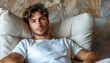 © Echelon IMG - handsome young man sits in a relax chair in the living room at home