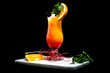 Tequila sunrise on a black background, on a marble tray