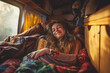 Happy smiling hippie woman sleeping inside vintage camper van with copy space