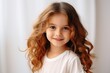 Portrait of a cute young girl on a light background.