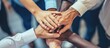 Diverse office workers joining hands symbolize strong productive teamwork. Cooperation and unity among business employees.