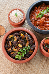 Poster - Spicy red beef fry curry and brown rice South Indian dish Kerala, India. side of Ghee rice, Appam, Parotta, Puttu. traditional Christian Muslim feast dish. Buffalo roast, meat pepper fry with coconut.