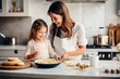 © Mykmicky - Mère et fille heureuses préparant des crêpes dans une cuisine moderne pour la Chandeleur
