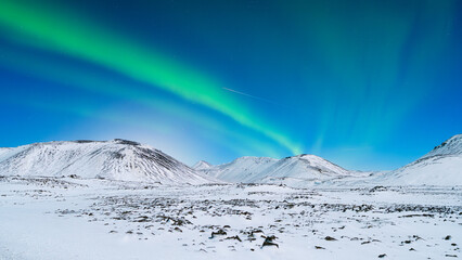 Wall Mural - Aurora Borealis. Northern Lights over the mountains. Scandinavia. Winter night landscape with bright lights in the sky. Landscape in the north in winter time.