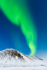 Wall Mural - Aurora Borealis. Northern Lights over the mountains. Scandinavia. Winter night landscape with bright lights in the sky. Landscape in the north in winter time.