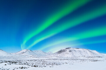 Wall Mural - Aurora Borealis. Northern Lights over the mountains. Scandinavia. Winter night landscape with bright lights in the sky. Landscape in the north in winter time.