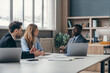 © gstockstudio - Three confident young people in formalwear discussing business during the meeting in the office