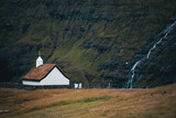 Fototapeta Na ścianę - small white nordic church with a waterfall and mountains