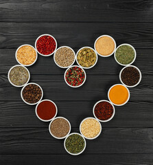 Wall Mural - Heart shape of assorted spices in bowls