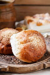 Poster - Sweet homemade buns on rustic wooden table. Delicious breakfast.