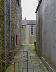 Romantic backstreet, side street and alleys in historic old town of Kirkwall, Scotland with historic Gothic architecture facades, a landmark sightseeing tourist spot in downtown Orkney Islands