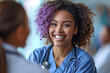 A young black female medical doctor smiling