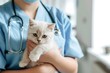 A veterinarian in a blue uniform gently cradles a white domestic cat with heterochromia, symbolizing professional pet care..
