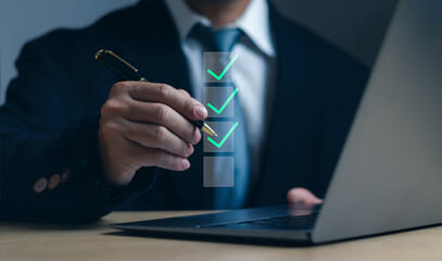 Poster - Businessman uses pen to answer exam questions with virtual screen on laptop computer at work desk, concept of Online surveys, fill out form and take online exams