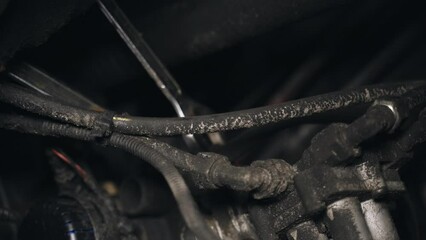 Poster - A mechanic unscrews the nuts with a tool to remove a part attached to the chassis of a truck. Close-up.
