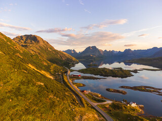 Wall Mural - Selfjord in Lofoten, Norway, at sunset. Panorama of the mountains. Calm sea, reflections in  the fjord. Mostly clear sky. Warm colors. E10 road to Reine.