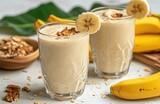 Fototapeta Do pokoju - a vegan banana smoothie is shown in glasses