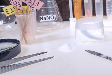 A laboratory technician examines a white powder. Food additives, medicinal powder, antibiotic. laboratory, research.