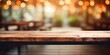 © Sona - Blurred coffee shop background with wooden table upfront.
