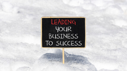 Wall Mural - Leading your business to success symbol. Concept words Leading your business to success on beautiful blackboard. Beautiful snow background. Leading your business to success concept. Copy space