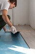 © scharfsinn86 - Man is repairing the floor in the house, laminate flooring
