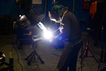 Professional welder at work in industrial environment