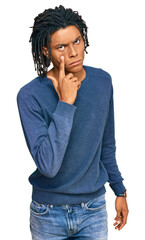 Wall Mural - Young african american man wearing casual winter sweater pointing to the eye watching you gesture, suspicious expression