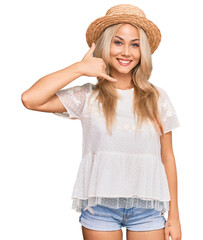 Canvas Print - Young blonde girl wearing summer hat smiling doing phone gesture with hand and fingers like talking on the telephone. communicating concepts.