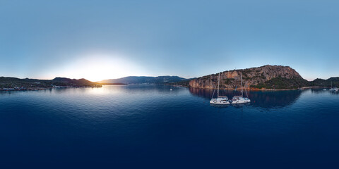 Wall Mural - Evening panoramic view of the bay of the ancient Lycian city of Saba near the modern city of Kas in Antalya province, Turkey. Sailing yachts at anchorage. Seamless 360 degree spherical panorama