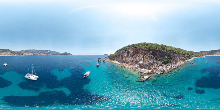 Sailing yachts and boats are anchored near a rocky shore in the Mediterranean Sea, Antalya Province, Turkey. Aerial seamless 360 degree spherical panorama