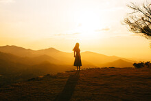 Silhouetted Woman Enjoying Sunset Over Mountains In Minca, Colombia