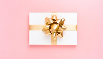 Canvas Print - blank gift card with golden bow on pink background top view space for text